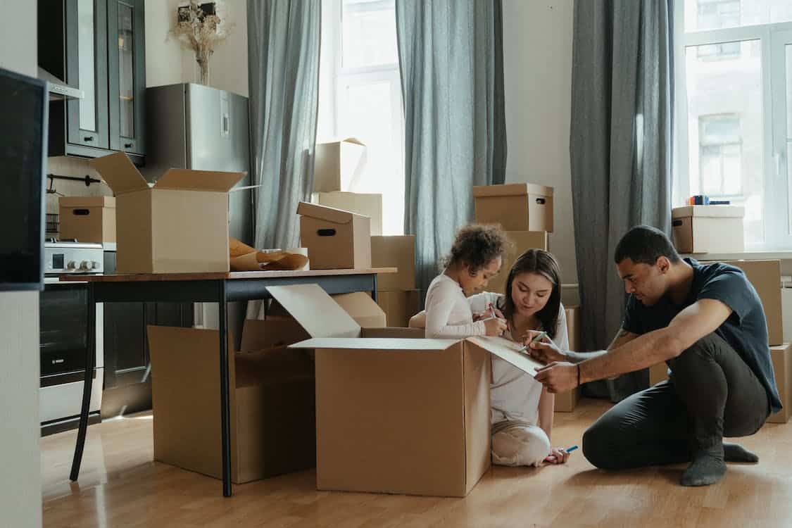 Description: Free Family Unpacking After Moving Stock Photo